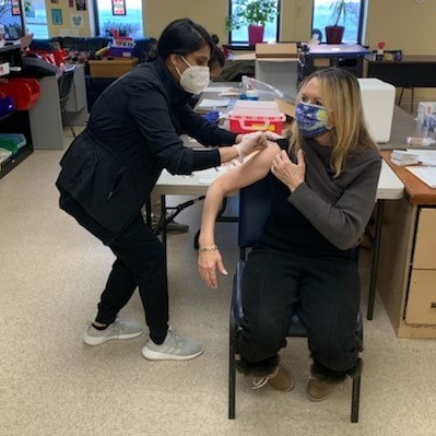 Woman getting vaccine at clinic